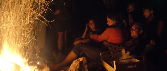 Picture 4: People sitting around campfire